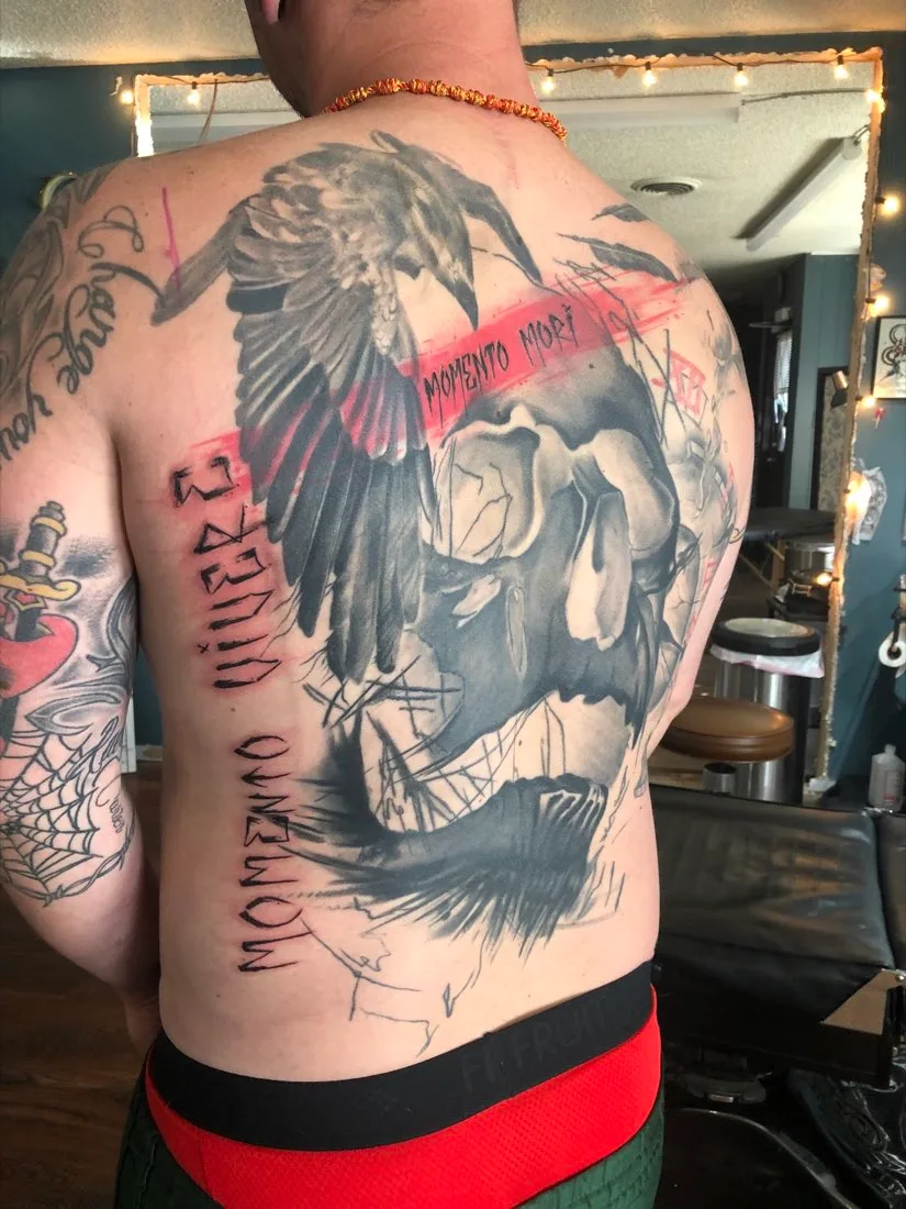 A client's large back piece, photographed inside the studio