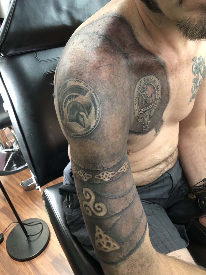 Black and grey shoulder and arm work with knot patterns